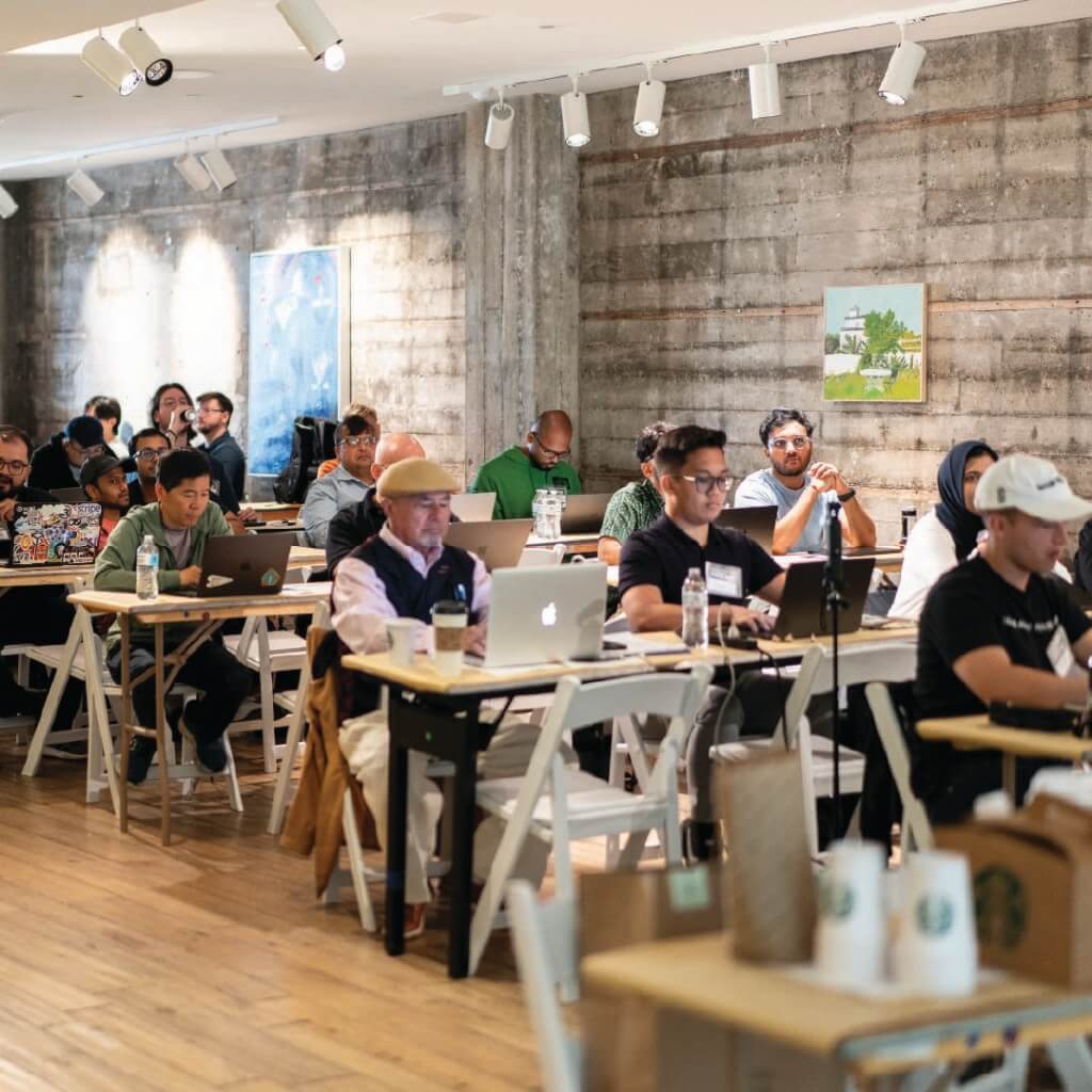 Attendees participating in a hands-on AI workshop during Day ZERØ